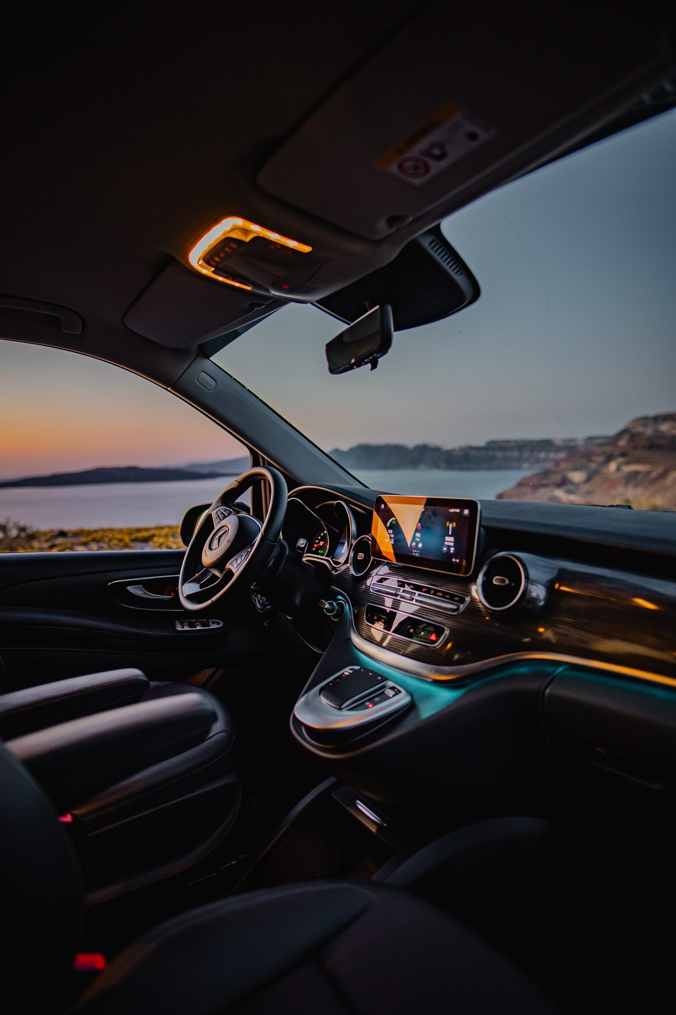 Mercedes-Benz V-Class interior with ambient lighting and views over the Santorini caldera
